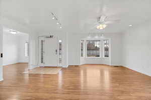 Interior space with light wood-style flooring, ceiling fan, and plenty of natural light