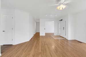 Interior space featuring ceiling fan, crown molding, track lighting, and light wood-type flooring