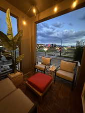 Patio terrace at dusk featuring a balcony