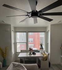 Dining space with light wood-type flooring, a wealth of natural light, and ceiling fan