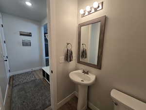 Bathroom with toilet and wood-type flooring