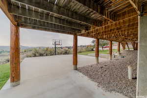 View of patio / terrace with basketball hoop and a mountain view