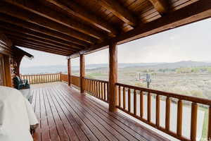 Wooden terrace featuring a mountain view