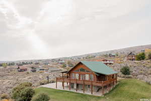 Exterior space featuring a yard, a patio, and a wooden deck