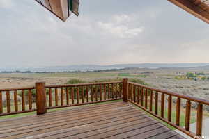 Wooden deck featuring a mountain view and a rural view