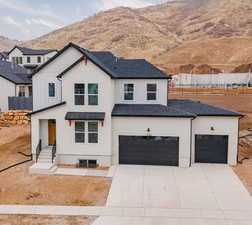 Modern farmhouse with a garage and a mountain view