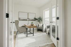 Living area with wood-type flooring and french doors