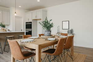 Dining room with light hardwood / wood-style flooring