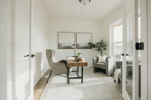 Sitting room with light hardwood / wood-style flooring and french doors