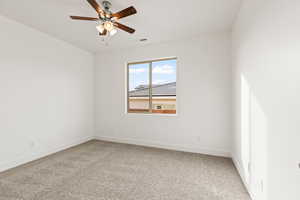 Unfurnished room featuring carpet floors and ceiling fan