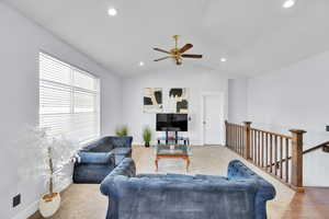 Living room with ceiling fan and vaulted ceiling