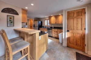 Kitchen with a kitchen breakfast bar, kitchen peninsula, and stainless steel appliances