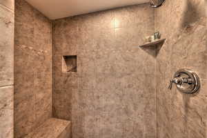 Bathroom featuring tiled shower