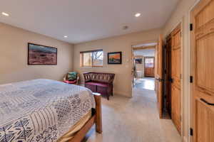 Bedroom featuring light carpet and a closet