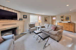 Carpeted living room with a fireplace