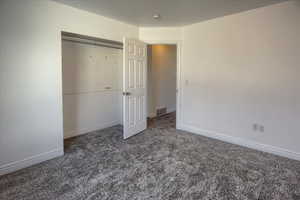 Unfurnished bedroom with a closet and carpet