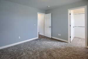 West bedroom with carpet flooring