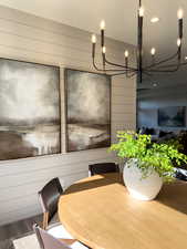 Unfurnished dining area with hardwood / wood-style floors and wood walls