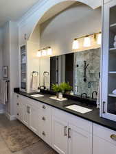 Bathroom featuring vanity, tile patterned floors, and an enclosed shower