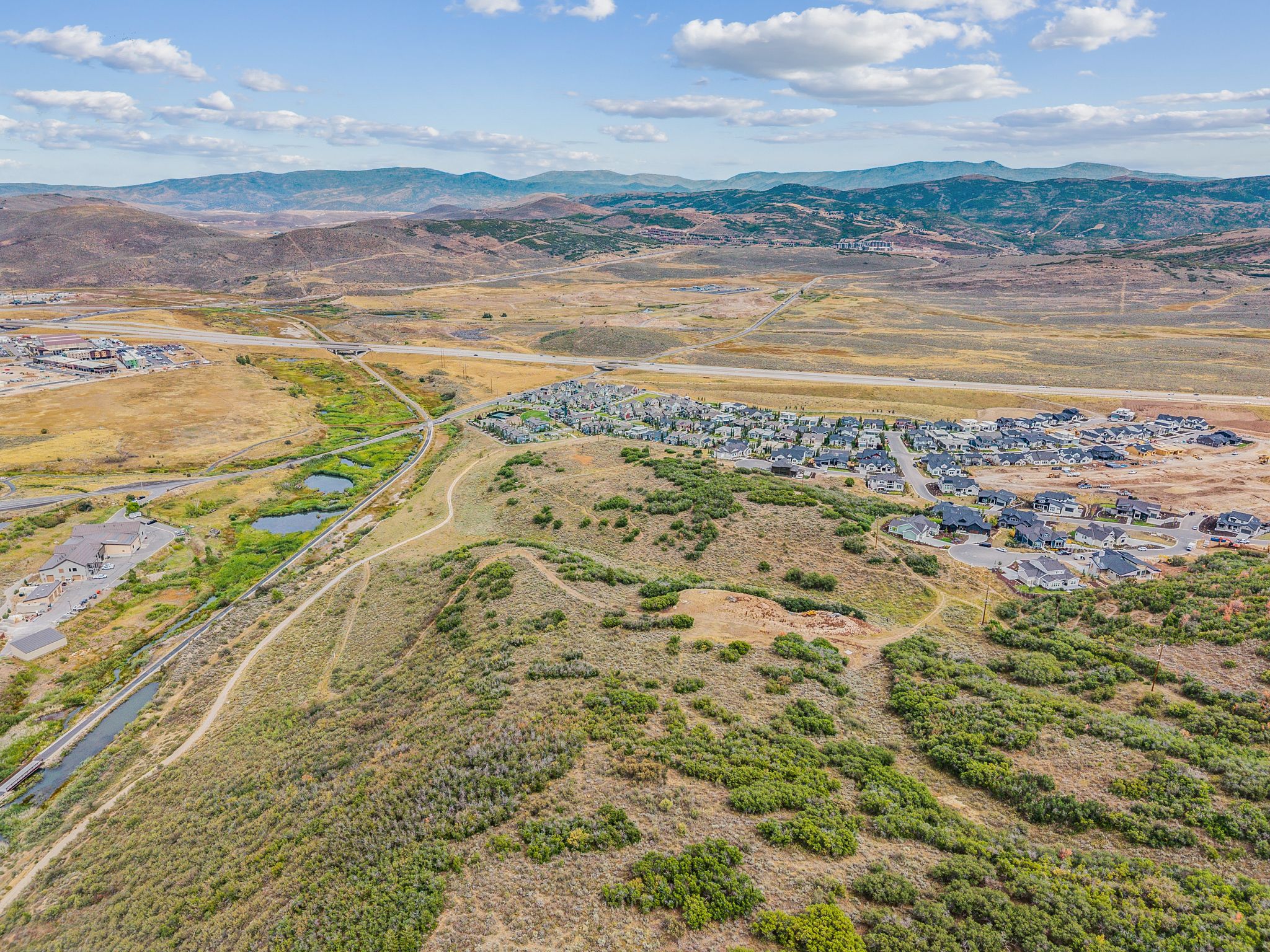 Aerial view of property and surrounding area with rural landscape and a water and mountain view