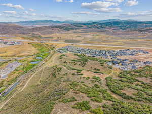 Aerial view of property and surrounding area with rural landscape and a water and mountain view