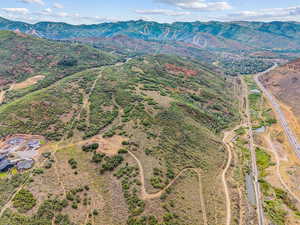 Aerial view of property and surrounding area with mountains