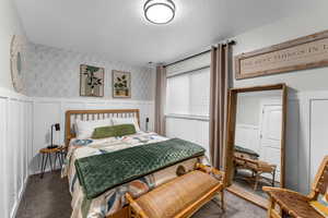 Carpeted bedroom with a textured ceiling