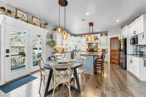 Dining room featuring light hardwood / wood-style floors and a textured ceiling