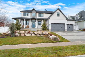 View of front of property with a garage and a front yard