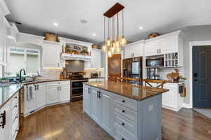 Kitchen with white cabinets, stainless steel appliances, and a kitchen island