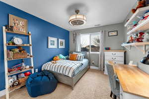 Bedroom featuring light colored carpet and a textured ceiling