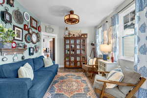 Living room with a textured ceiling, hardwood / wood-style floors, and plenty of natural light