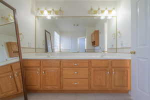 Bathroom with tile patterned flooring and vanity