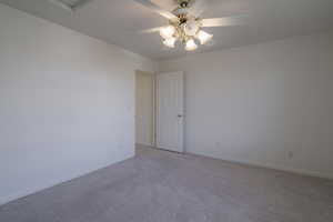 Unfurnished room with ceiling fan and light carpet