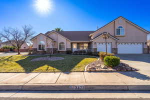 Ranch-style house with a front yard and a garage