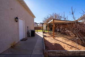 View of yard featuring cooling unit and a patio area