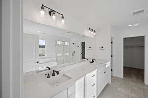 Bathroom featuring tile patterned floors, vanity, and plus walk in shower