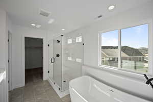 Bathroom with tile patterned flooring and separate shower and tub