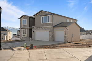 View of front of property featuring a mountain view and a garage