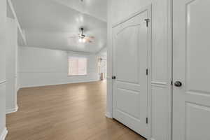 Interior space with light hardwood / wood-style flooring, ceiling fan, and lofted ceiling