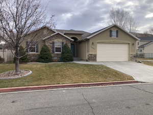 Single story home with a front yard and a garage