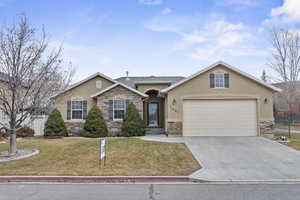 Ranch-style house featuring a front yard and a garage