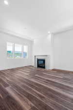 Unfurnished living room featuring dark hardwood / wood-style floors