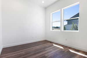 Unfurnished room with dark hardwood / wood-style floors