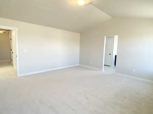 Primary bedroom with lofted ceiling