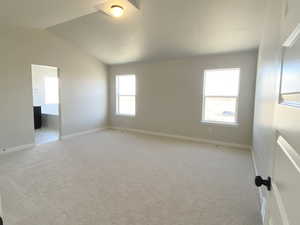 Primary bedroom with lofted ceiling