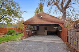 View of parking / parking lot with a carport