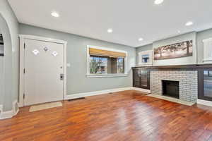 Foyer with a fireplace and hardwood / wood-style floors