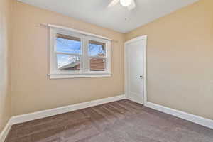 Unfurnished room with ceiling fan and carpet floors