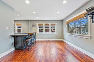 Bar with dark wood-type flooring